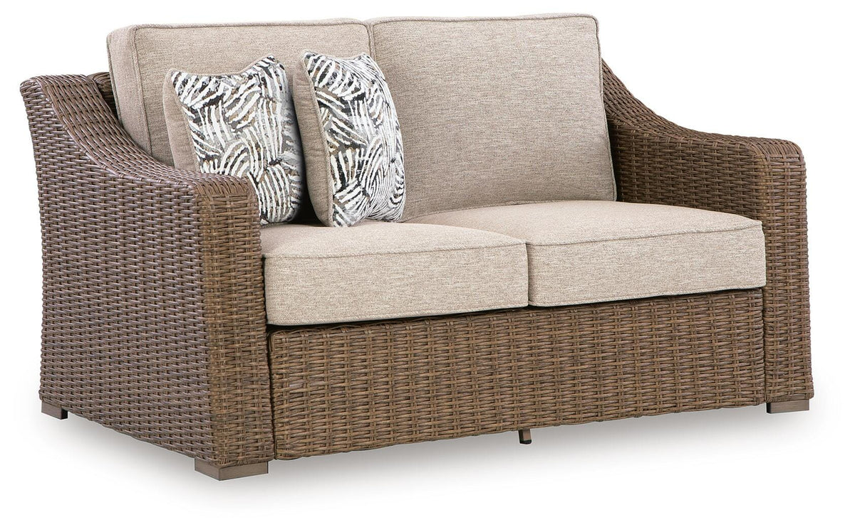 Beige, full loveseat with cushions and two pillows