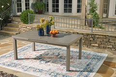 71–94-Inch Wood-Look Aluminum Outdoor Extension Dining Table, shorter configuration in a patio setting - 6