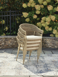Beige, four chairs stacked in outdoor setting - 3