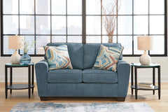Blue, complete loveseat in a room; accessories excluded - 2