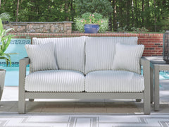 Gray, outdoor loveseat beside a pool - 2