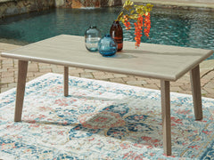 Beige, outdoor dining table beside a pool - 2