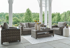 Gray, four-piece seating set in a patio setting - 2