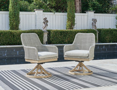 Gray, pair of swivel chairs in an outdoor setting - 2